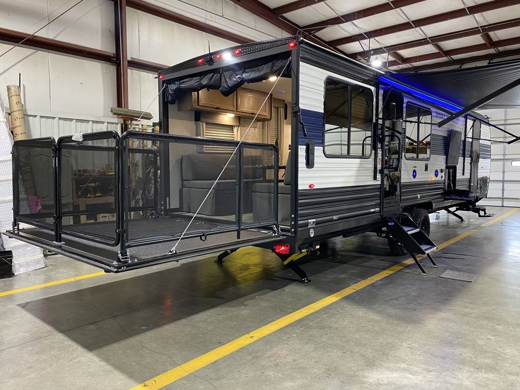 Side view of the New 2024 Forest River Cherokee Grey Wolf 26MBRR Travel Trailer Toy Hauler RV.