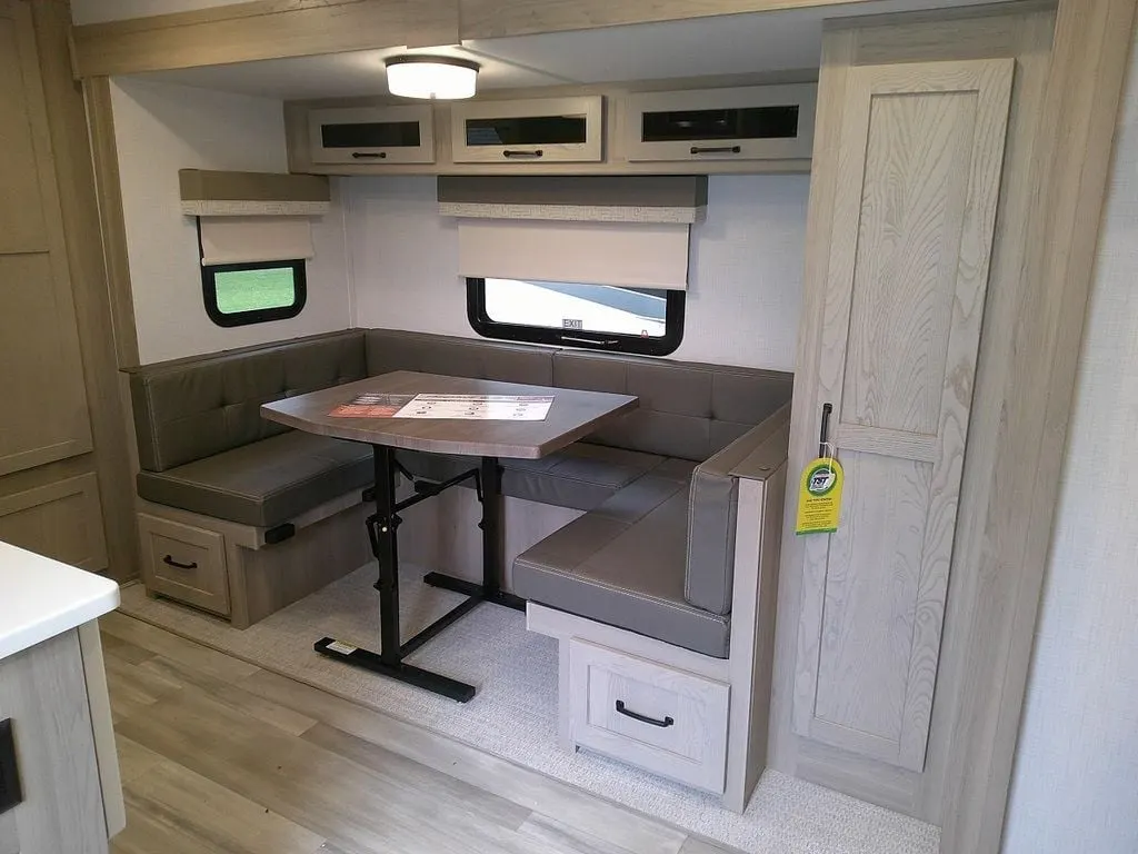 Dinette with overhead cabinets and pull-out storage drawers.