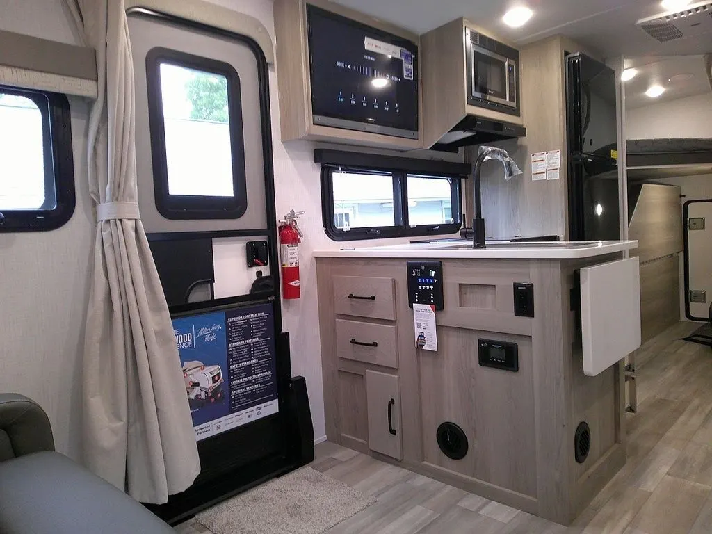 Kitchen with a gas range, fridge, oven, sink and cabinets.