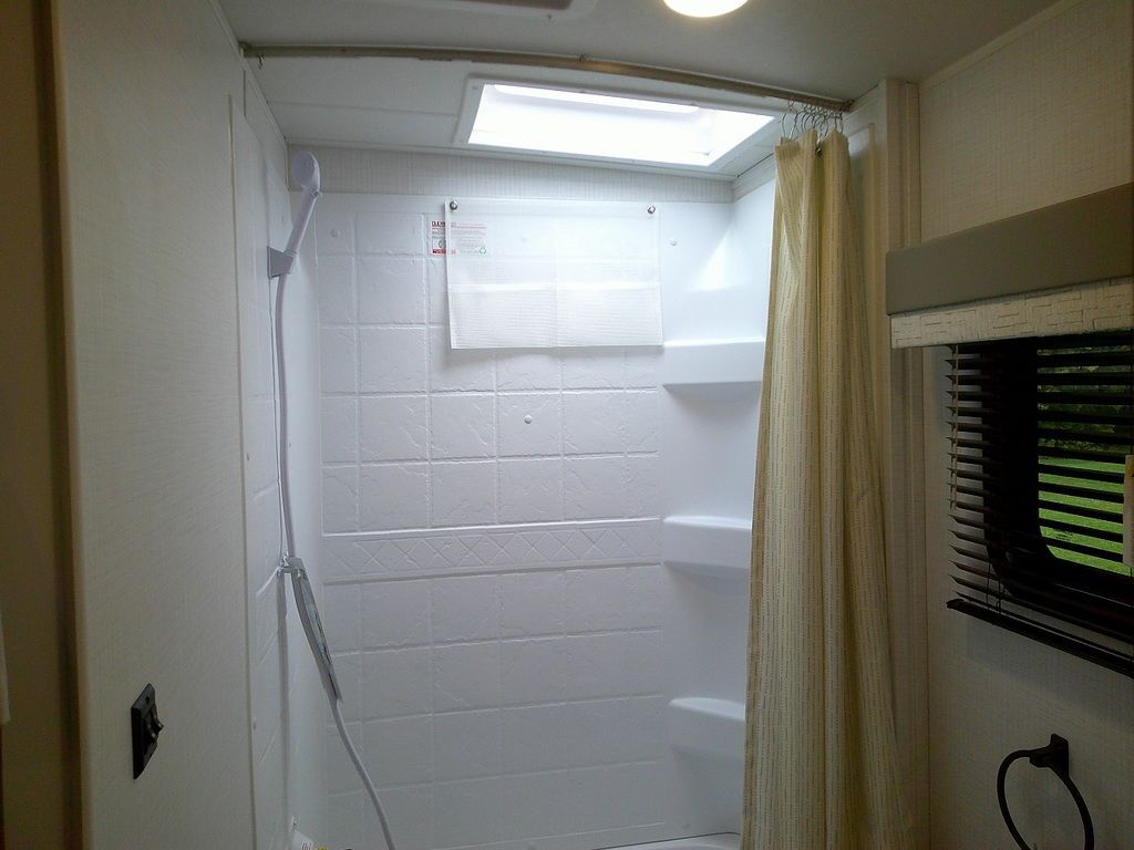 Bathroom with a walk-in shower and a skylight.