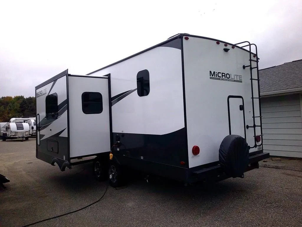 Side view of the New 2024 Forest River Flagstaff Micro Lite 25BRDS Travel Trailer RV.