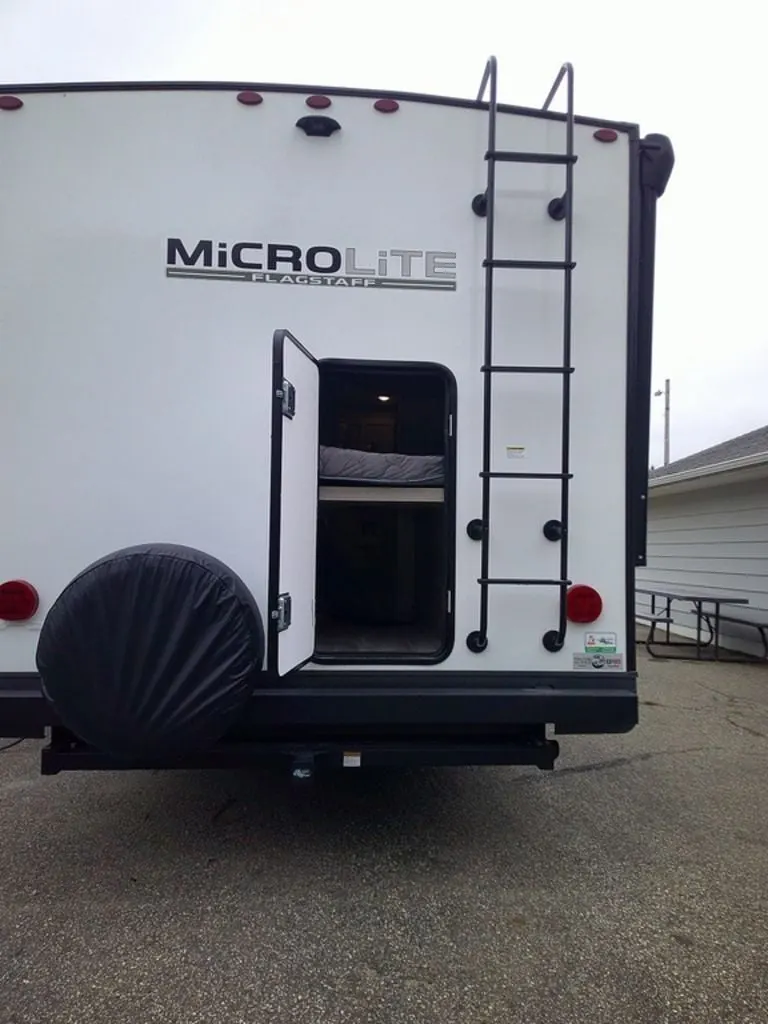 Rear view of the New 2024 Forest River Flagstaff Micro Lite 25BRDS Travel Trailer RV.