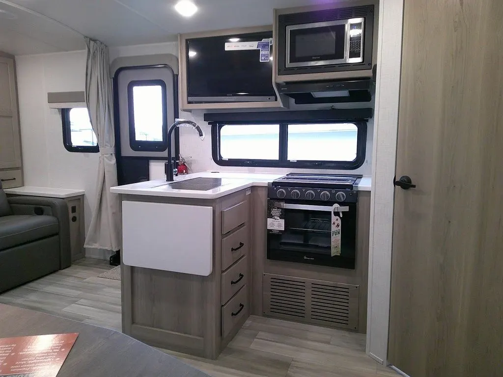 Kitchen with a gas range, oven, sink and cabinets.