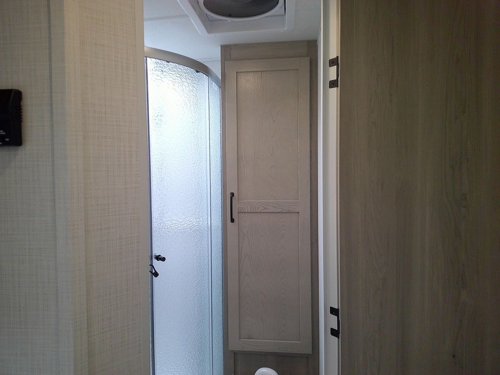 Bathroom with a linen and a walk-in shower.