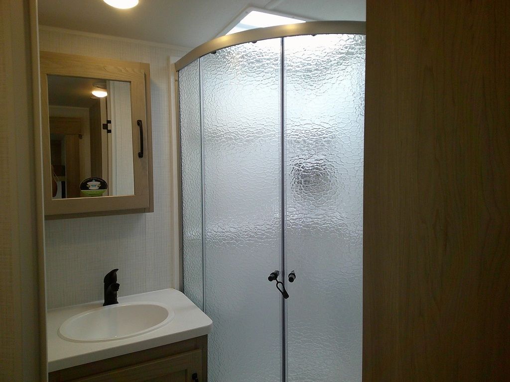 Bathroom with a sink, medicine cabinet and a walk-in shower.