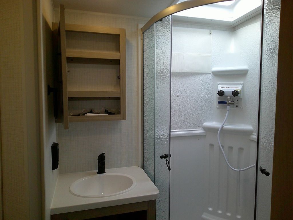 Bathroom with a sink, medicine cabinet and a walk-in shower.