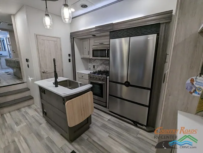 Kitchen with a gas range, fridge, oven, sink and cabinets.