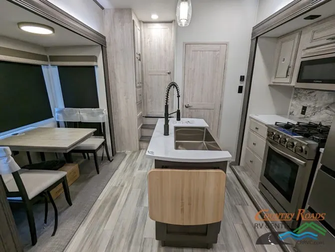 Interior view of the RV with a dinette and a kitchen.