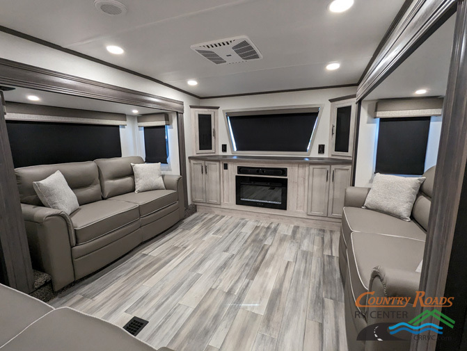 Living space with leather seats and and entertainment center.