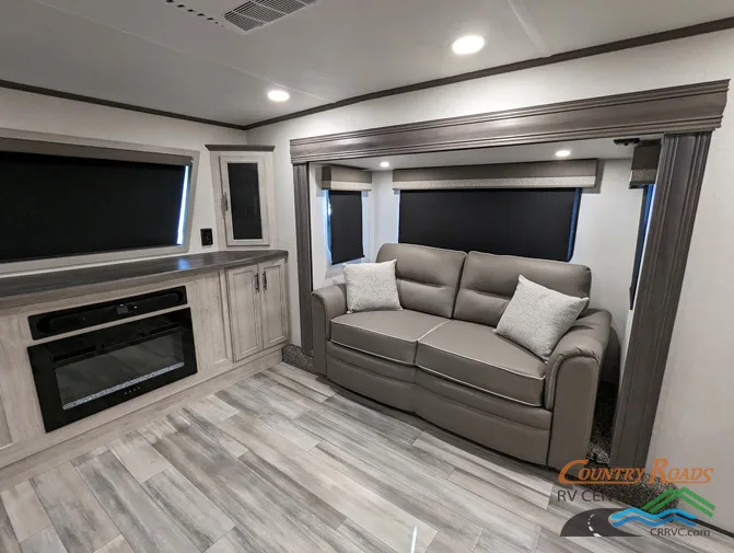 Living space with leather seats and and entertainment center.