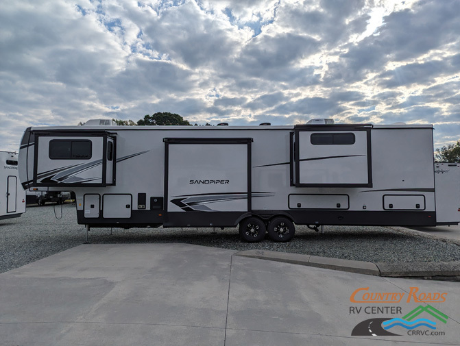 Side view of the New 2024 Forest River SANDPIPER 391FLRB Fifth Wheel RV.