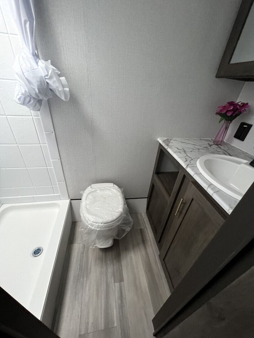 Bathroom with a sink, toilet and a walk-in shower.