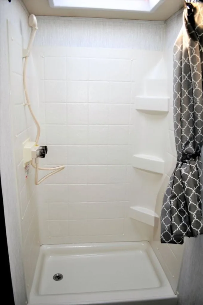 Bathroom with a walk-in shower and skylight.