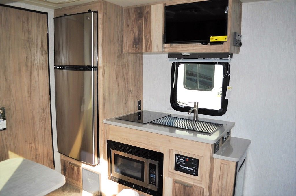 Kitchen with a gas range, fridge, oven, sink and cabinets.