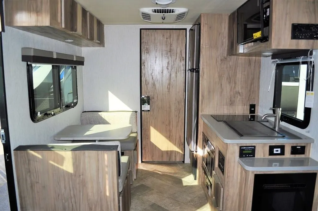 Interior view of the RV with a dinette and a kitchen.