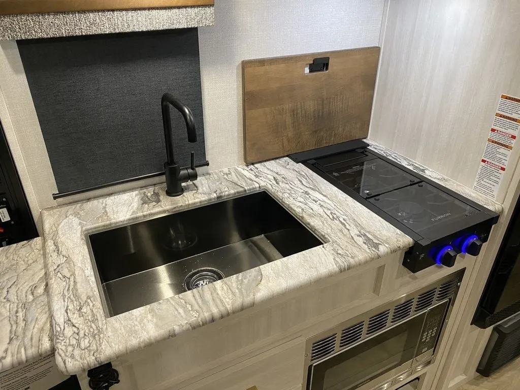 Kitchen with a gas range, sink and cabinets.