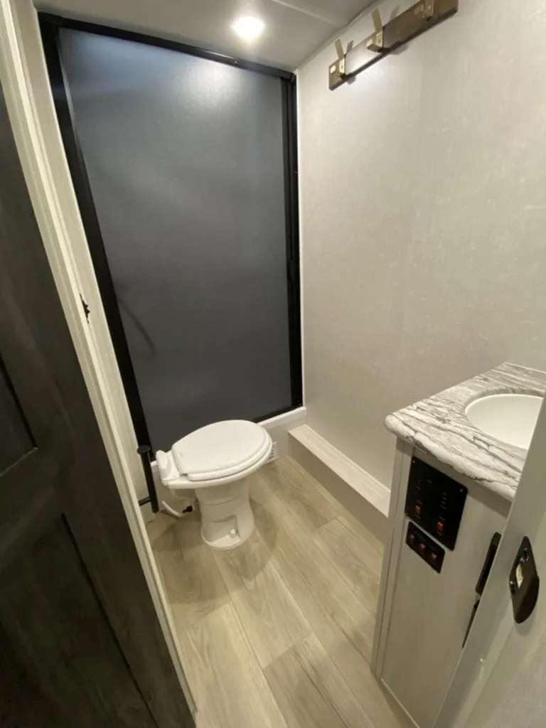 Bathroom with a sink, toilet and a walk-in shower.