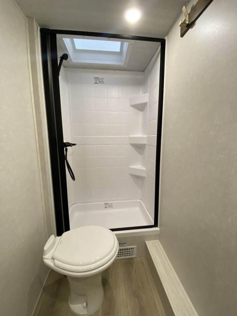 Bathroom with a toilet and a walk-in shower.