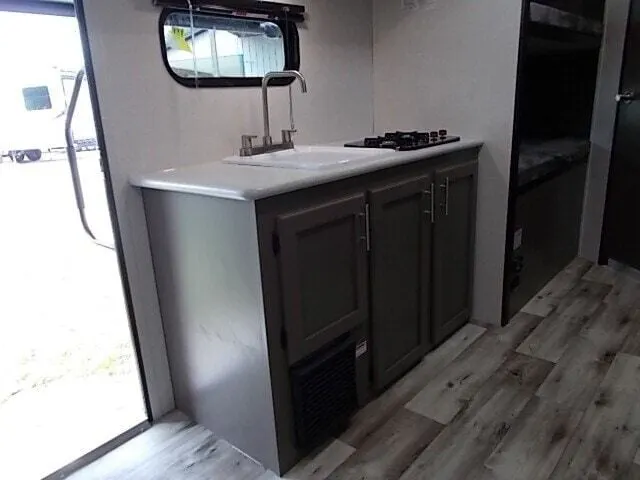 Kitchen with a gas range, sink and cabinets.