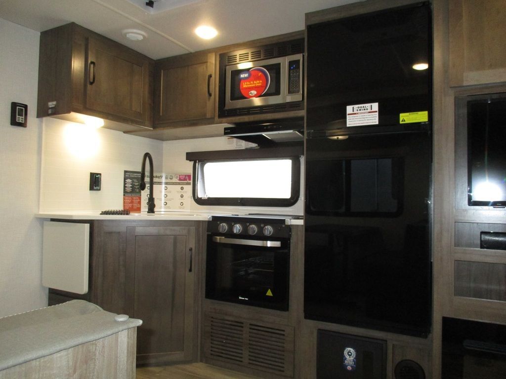 Kitchen with a gas range, fridge, oven, sink and cabinets.