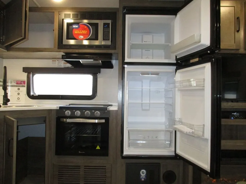 Kitchen with a gas range, fridge, oven, sink and cabinets.