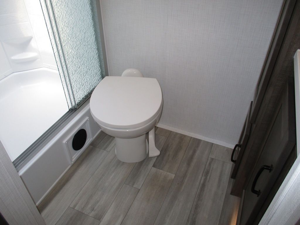 Bathroom with a toilet and a walk-in shower.