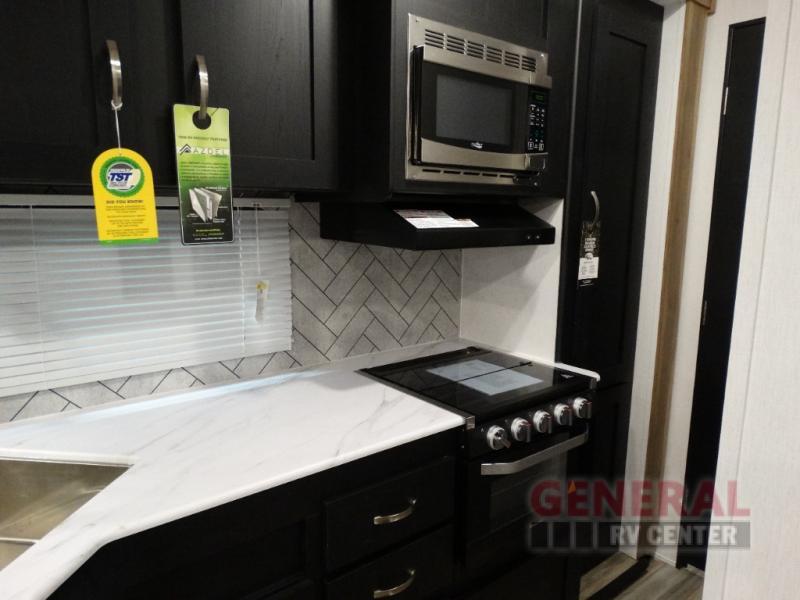 Kitchen with a gas range, oven, sink and cabinets.