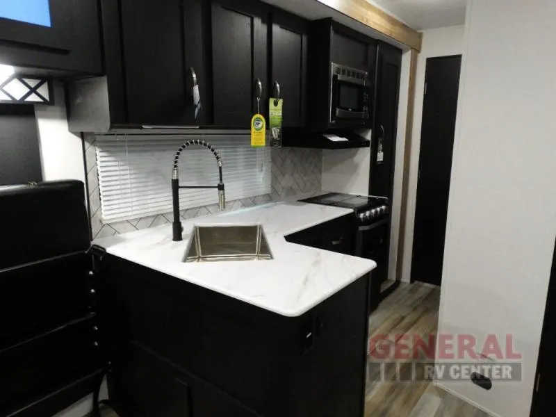 Kitchen with a gas range, oven, sink and cabinets.