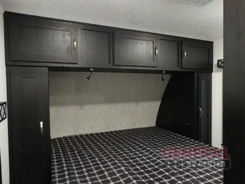 Bedroom with overhead cabinets.