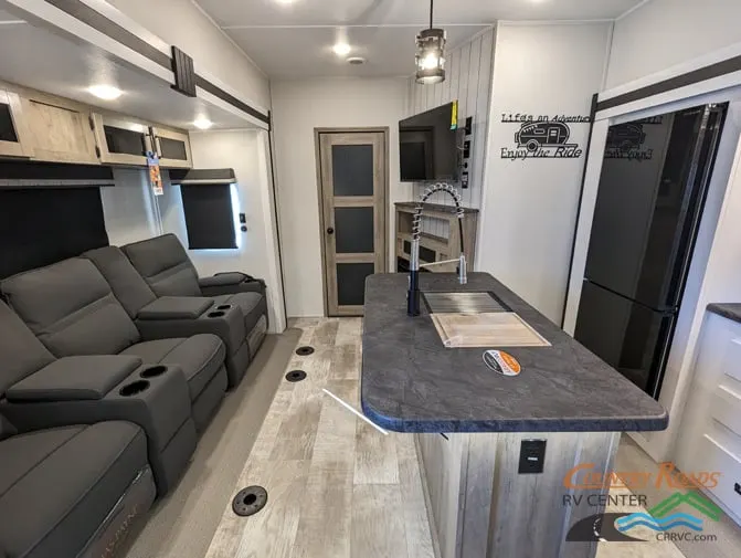 Interior view of the RV with a living space and a kitchen.