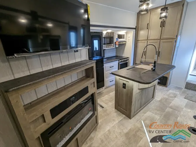 Entertainment center with a TV and a fireplace.