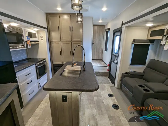 Interior view of the RV with a living space and a kitchen.