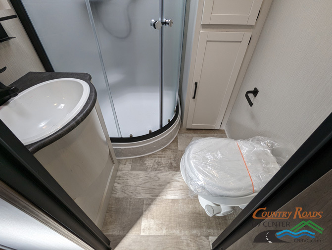 Bathroom with a sink, toilet and a walk-in shower.