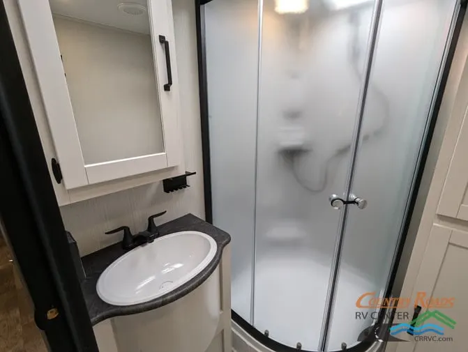 Bathroom with a sink, medicine cabinet and a walk-in shower.