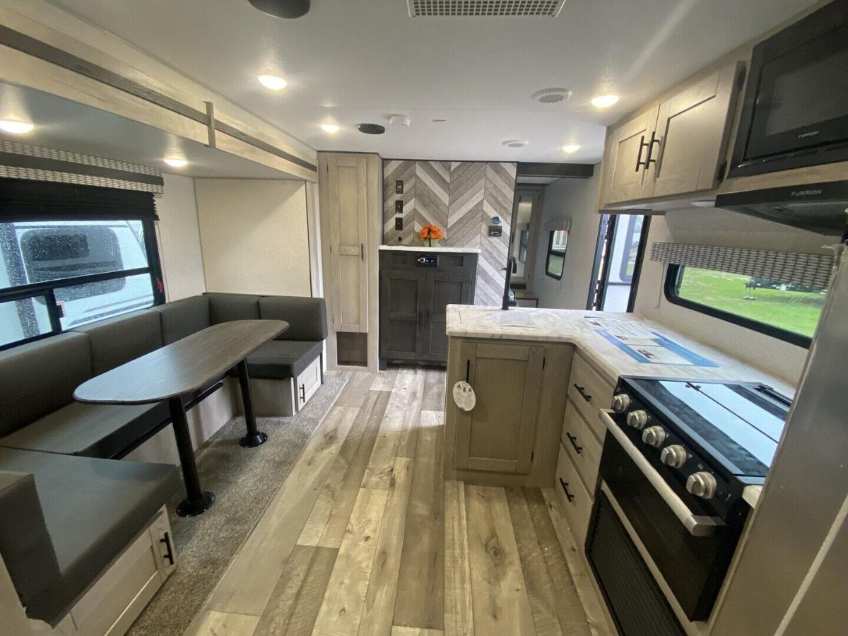 Interior view of the RV with a dinette and a kitchen.