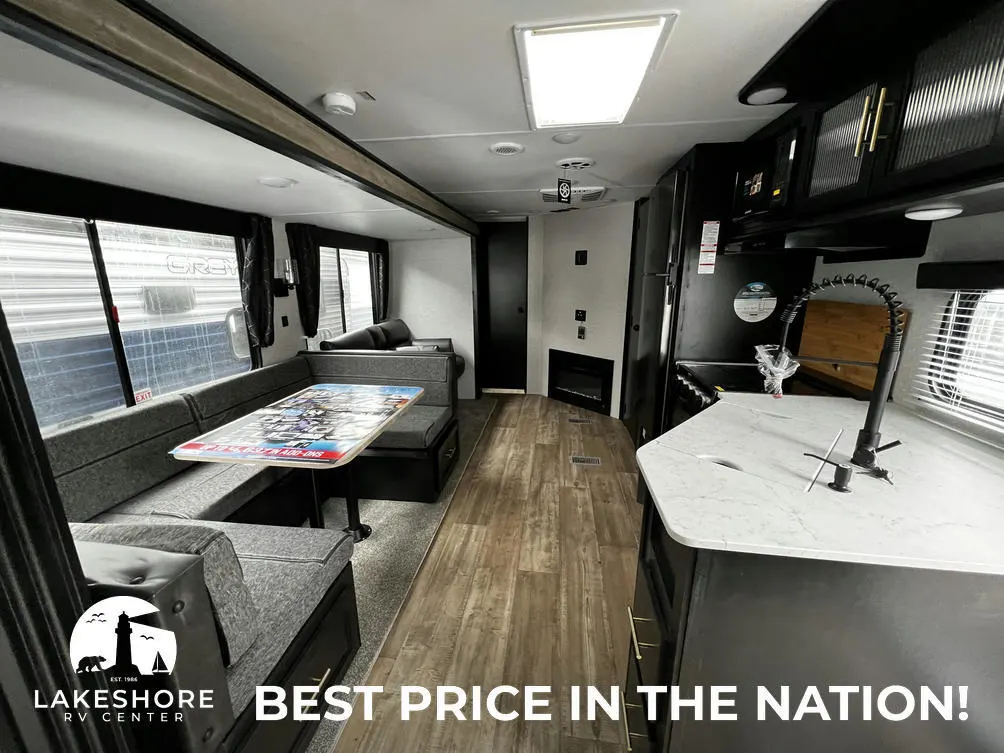 Interior view of the RV with a dinette, living space and a kitchen.