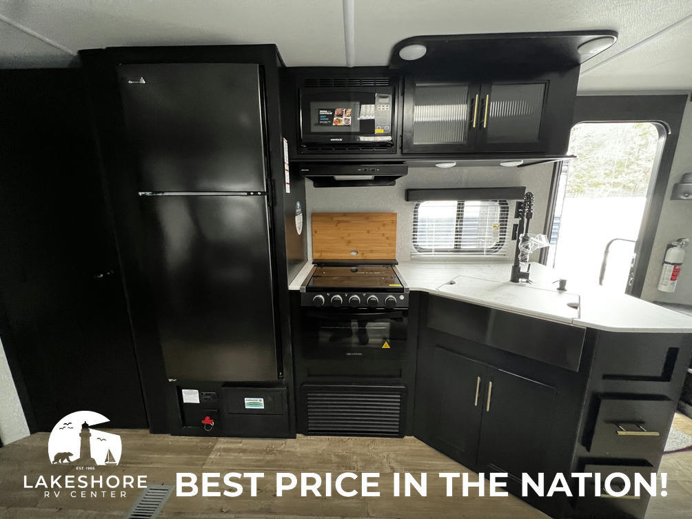 Kitchen with a gas range, fridge, oven, sink and cabinets.