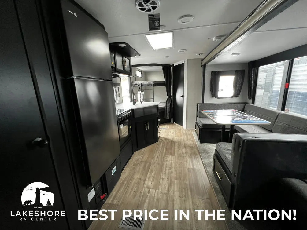 Interior view of the RV with a dinette, living space and a kitchen.