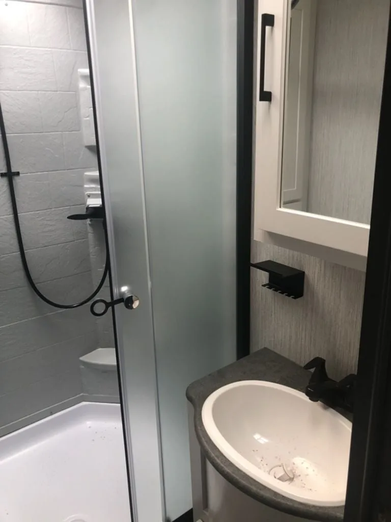 Bathroom with a sink and a walk-in shower.