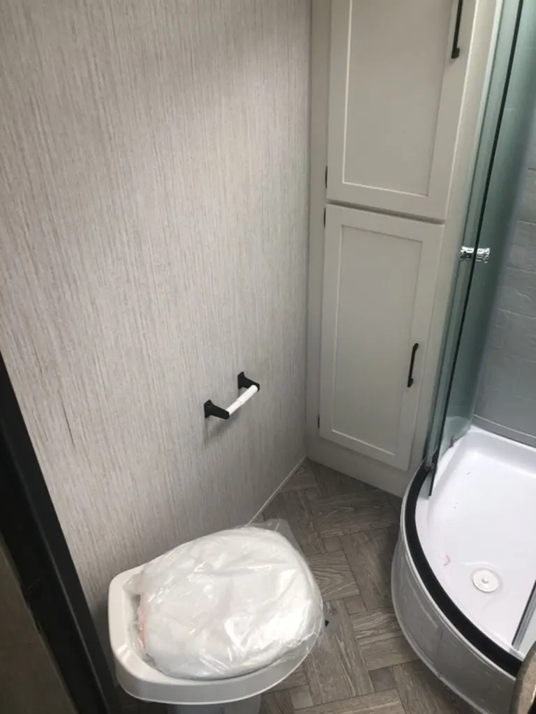 Bathroom with a toilet and a walk-in shower.