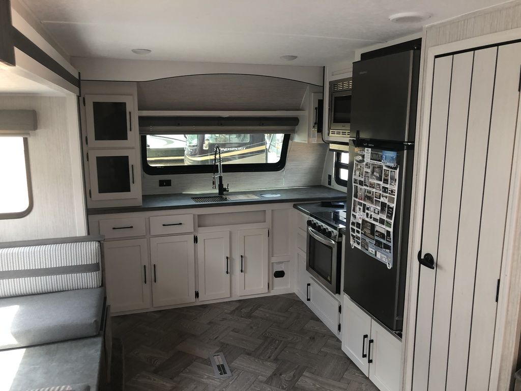 Kitchen with a gas range, fridge, oven, sink and cabinets.