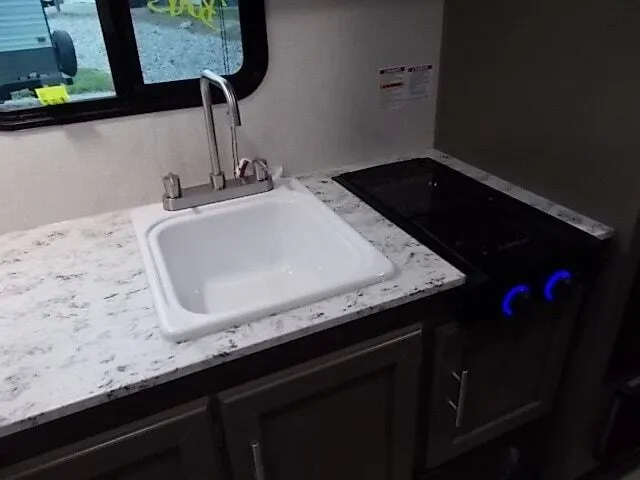 Kitchen with a gas range, sink and cabinets.