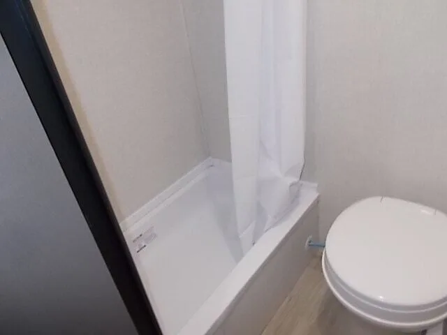 Bathroom with a toilet and a walk-in shower.