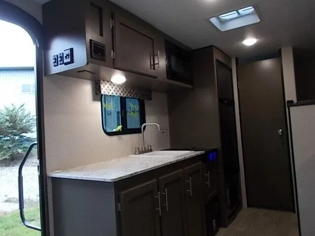 Kitchen with a gas range, oven, sink and cabinets.