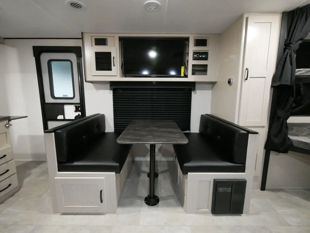 Dinette with overhead cabinets and a TV.