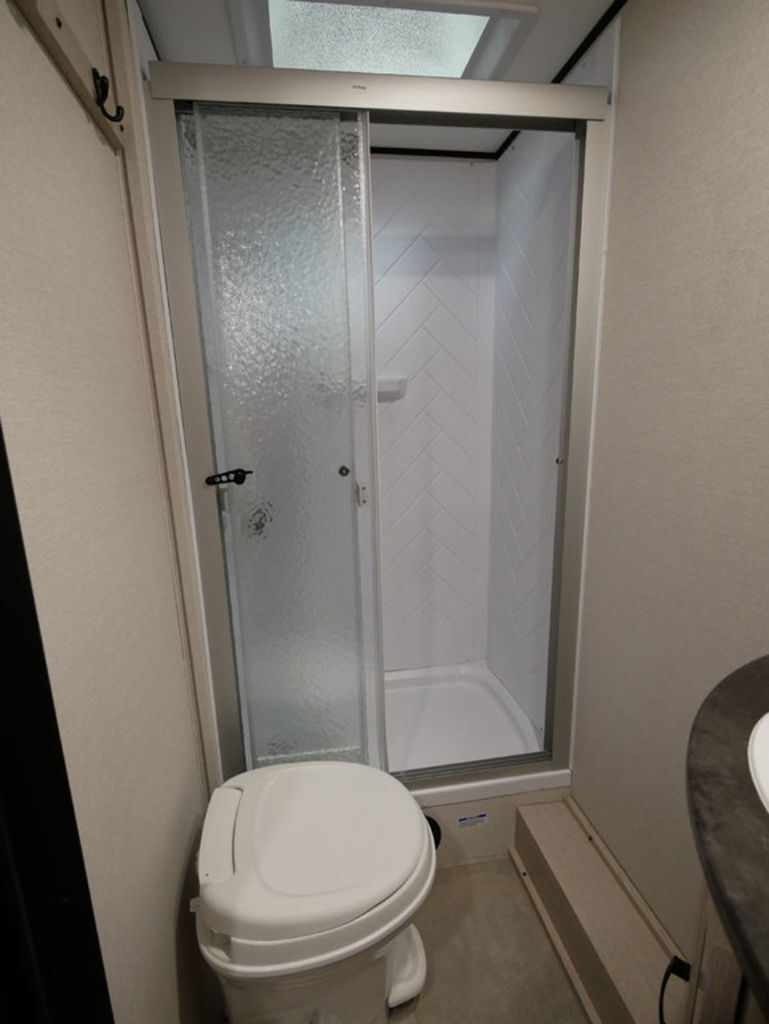 Bathroom with a toilet and a walk-in shower.