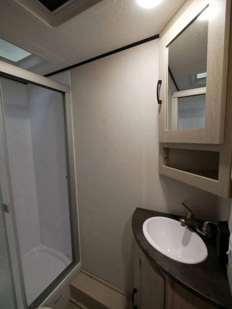 Bathroom with a sink, medicine cabinet and a walk-in shower.