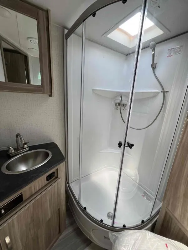 Bathroom with a sink, toilet and a walk-in shower.