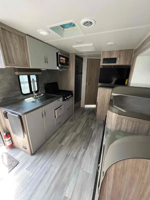 Interior view of the RV with a dinette and a kitchen.