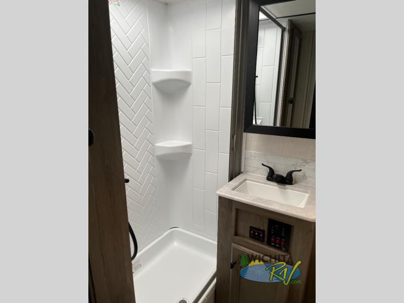 Bathroom with a sink and a walk-in shower.